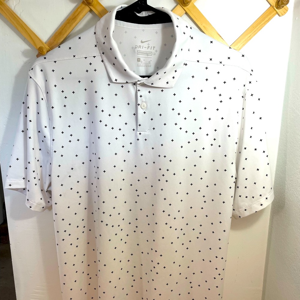 White Nike Dri Fit golf polo with details. Size medium. Nike logo on sleeve.